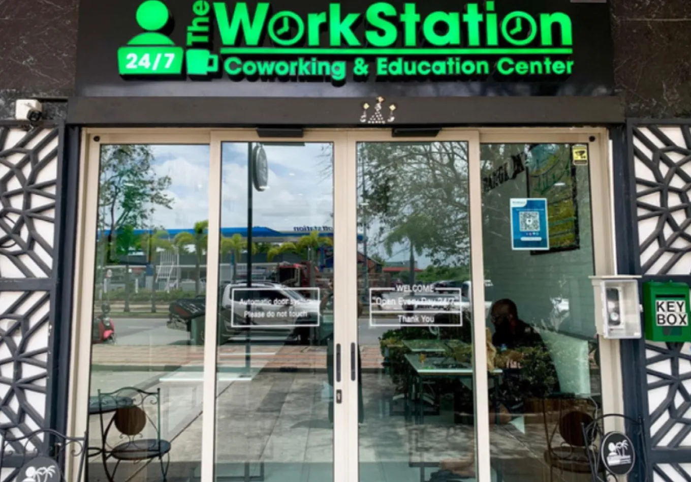 The WorkStation storefront in Pattaya, with its lit green sign